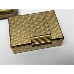 St Dupont gold plated cigarette lighter, with engine turned decoration, serial no EW1279, together with three powder compacts, including Stratton and Regent of London examples