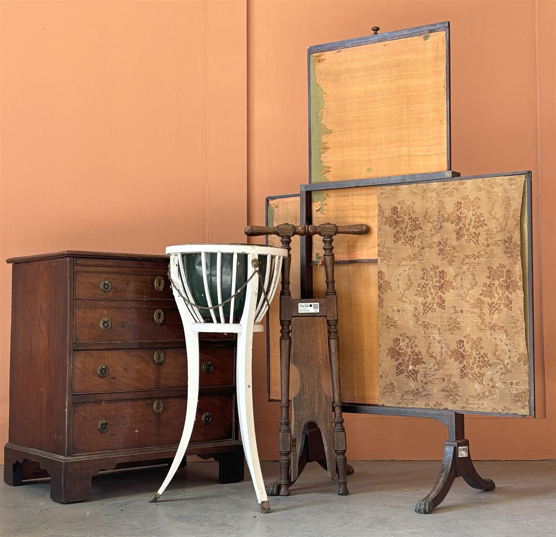 Late Regency mahogany fire screen with three silk lined panels, raised on four ebony strung and splayed supports with hairy paw brass terminals, together with an Edwardian white painted jardinière stand of Neoclassical design, an early 20th century oak boot jack, and a Georgian mahogany night commode with fall front cupboard over two drawers, on bracket supports (4) - COLLECTION BY APPOINTMENT FROM: The White House, Thirsk Road, Easingwold, York, YO61 3NF - CALL 01723 507111 TO ARRANGE