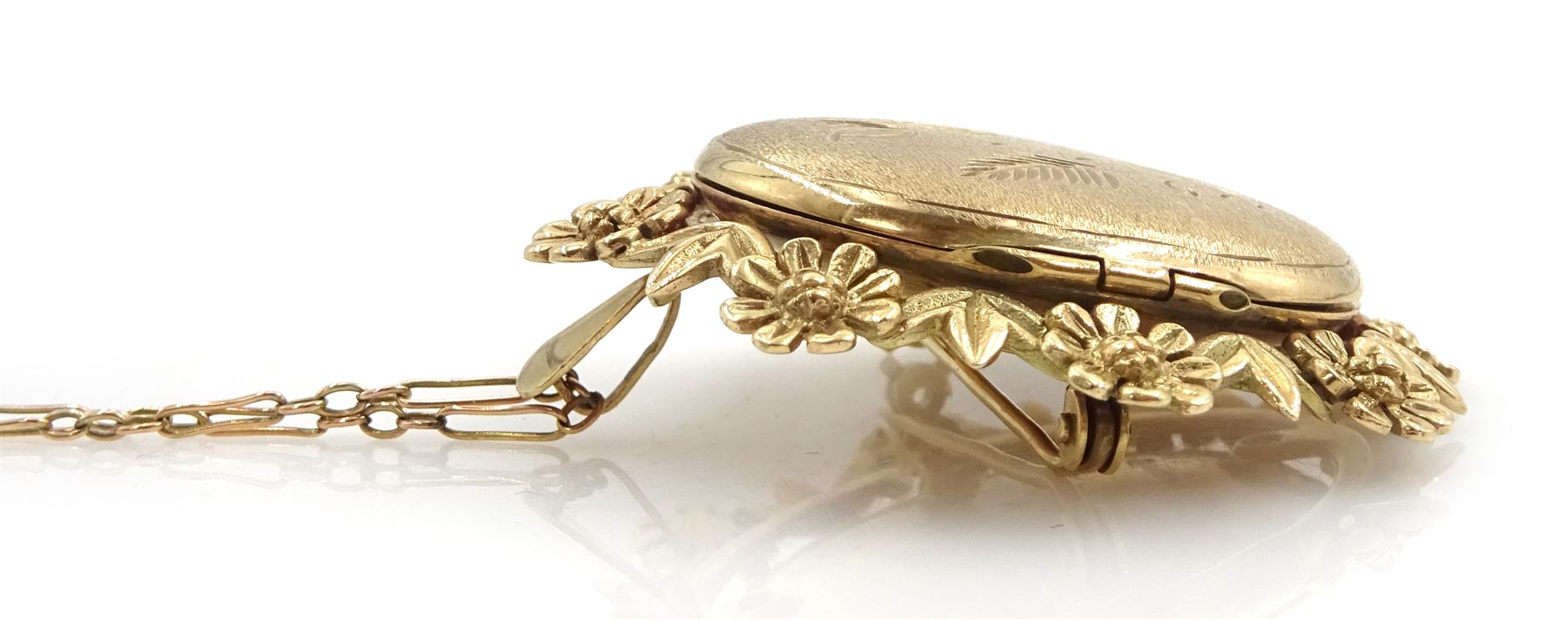 Gold hinged locket pendant/brooch, with foliate border, hallmarked, on 9ct gold link chain necklace