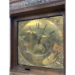 Early 19th century oak longcase clock, projecting cornice over frieze painted with scrolls, square glazed door enclosed by plain pilasters, square brass dial with ornate cast metal spandrels, Roman chapter ring and false subsidiary date aperture, engraved decoration and inscribed 'Torkington, Newcastle', 30-hour movement striking on bell