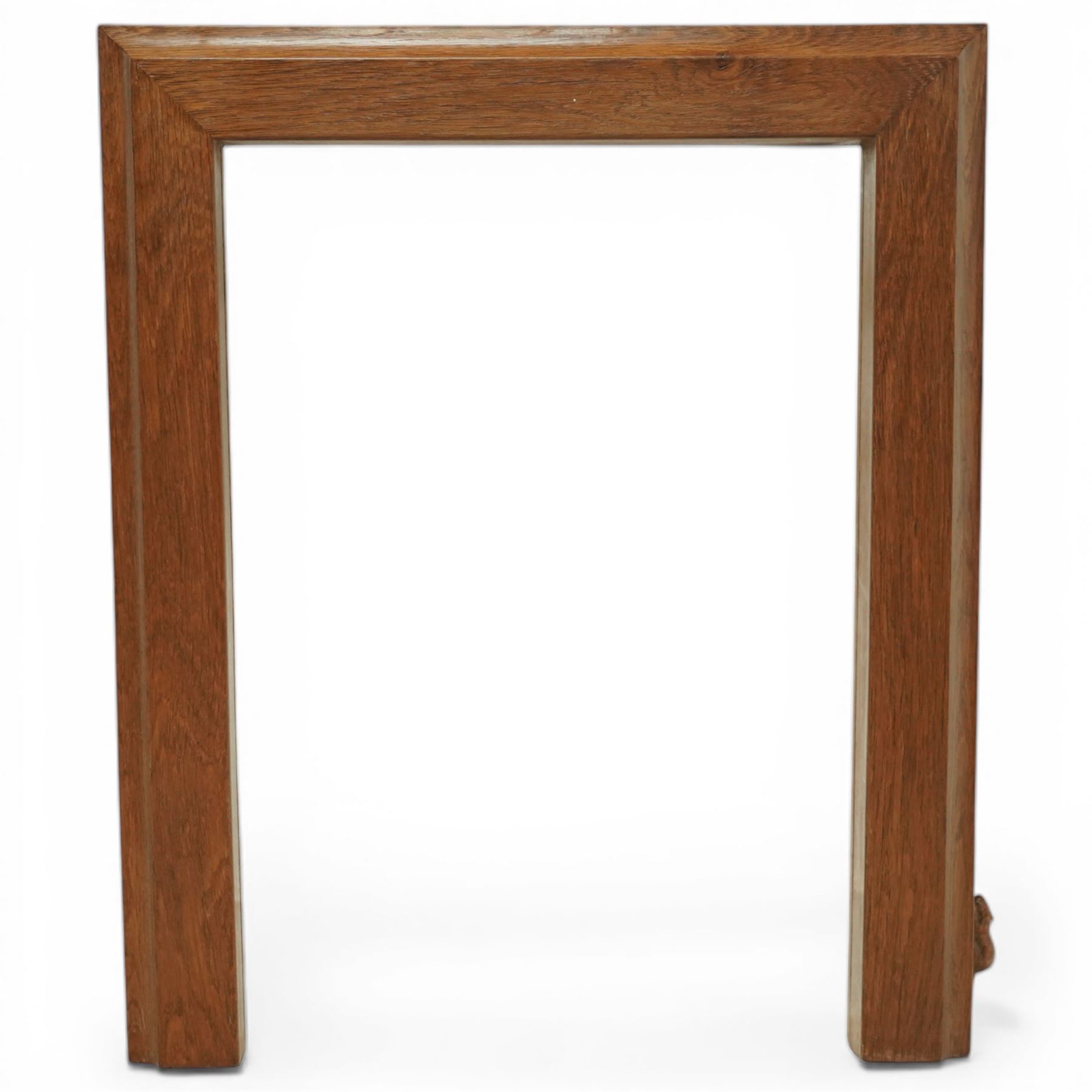 Beaverman - oak fire surround, moulded edge surrounding a rectangular aperture, with carved beaver signature, by Colin Almack of Sutton near Thirsk