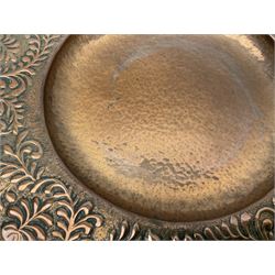 Arts and Crafts Keswick School of Industrial Arts copper charger, decorated with planished centre and repousse scrolling foliate tendrils to rim, D44cm