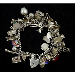 Heavy silver charm bracelet including fly in a spiders web, swan, horse in a stable, dogs, car, ballerina, pearl in a shell, mug, happy birthday spinner etc