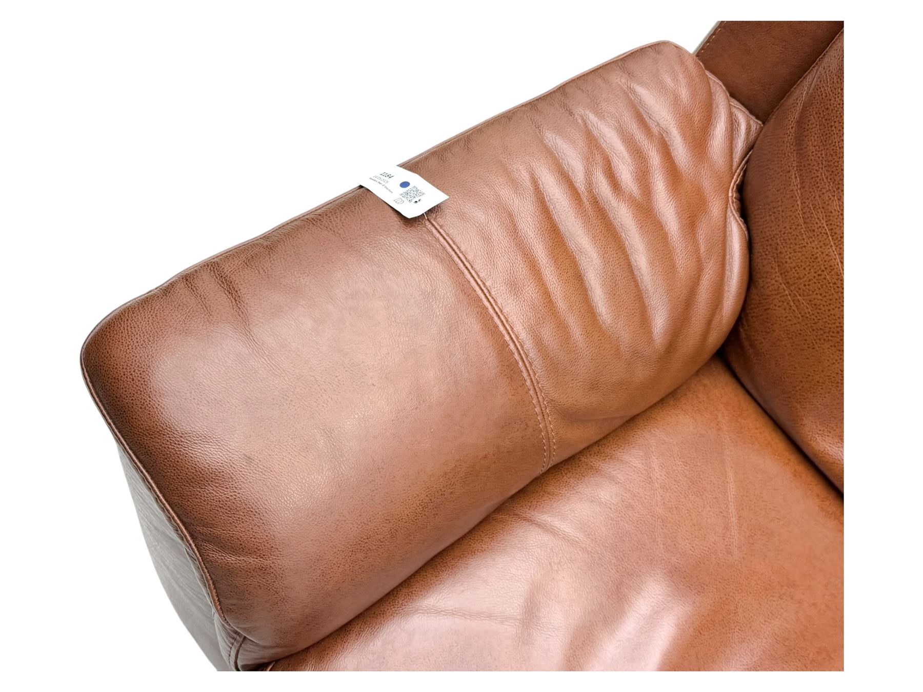 DFS - 'Liaison' reclining armchair upholstered in brown leather, upholstered in tan leather with stitched panel backrest and generously cushioned seat and arms, operated by wired remote, raised on block feet