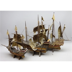  Three wooden models of three masted galleons, fully rigged with solid hulls, canvas sails and painted detail, on stands, L70cm, H58cm, max (3)   