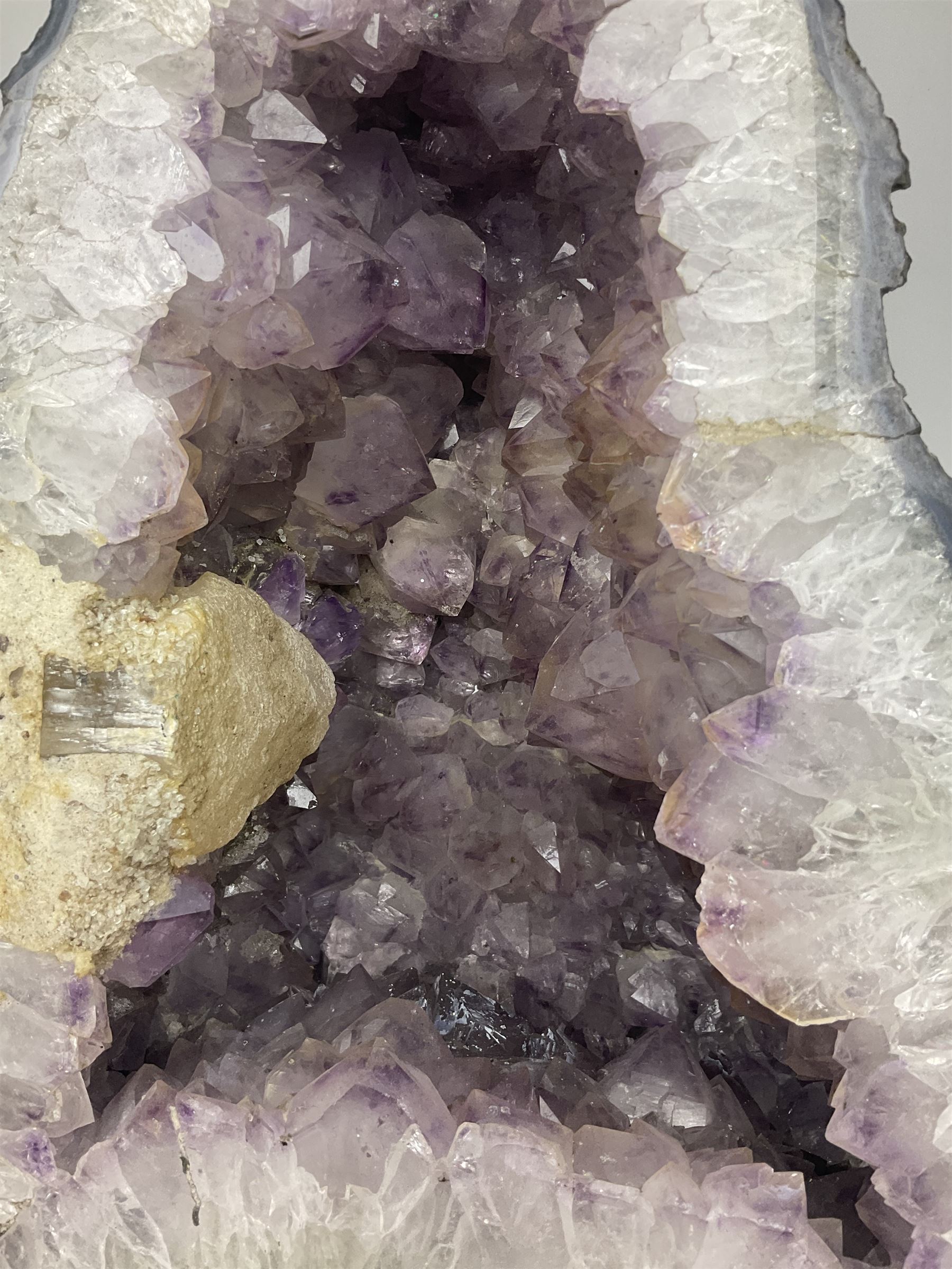 Amethyst crystal ‘cathedral’ geode, free standing with flat base and prepared outer surface, with well-defined crystals of various sizes within the cavern, H39, L32cm