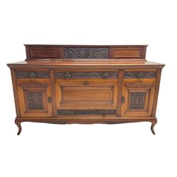 Edwardian carved walnut sideboard, raised back carved with shell and scrolling foliage, fitted with three drawers, two cupboards and fall front compartment, on cabriole feet