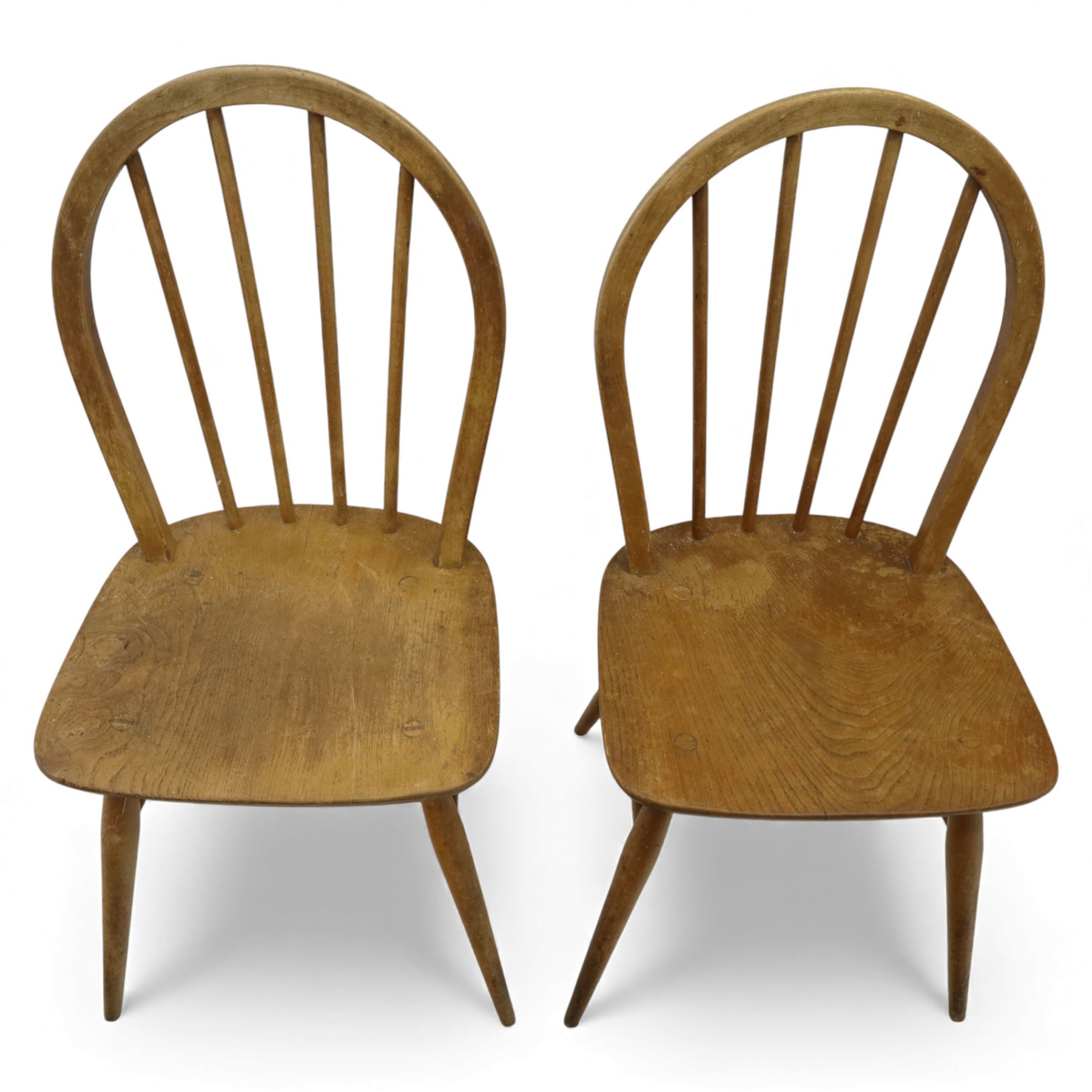 Ercol - Windsor dining chairs, set of four, each with rounded hoop back and four stick spindles, shaped elm seats with exposed plugs, raised on splayed beech tapering legs