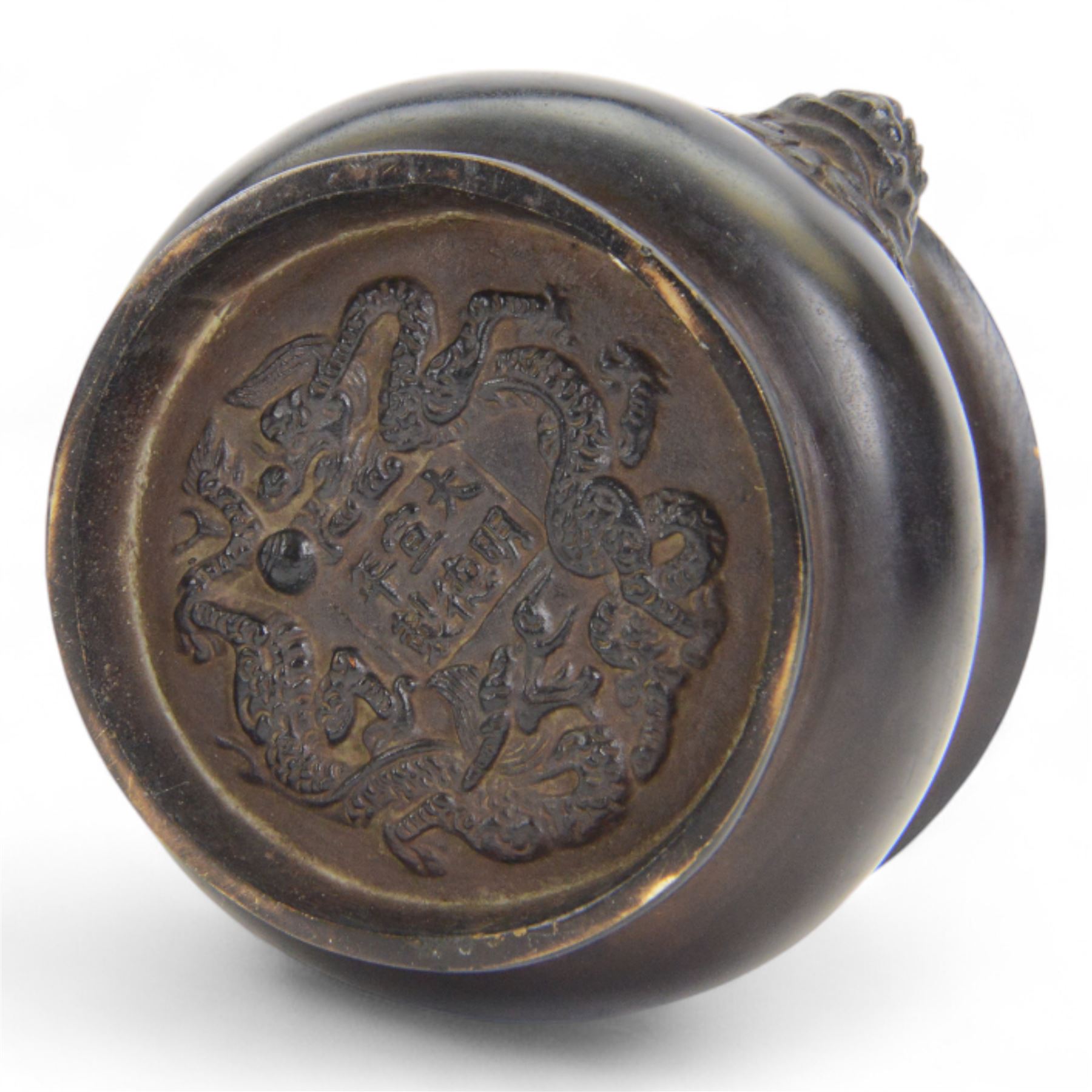 Chinese bronze censer, of circular bellied form with temple lion mask handles, upon a circular foot, with apocryphal six character Xuande mark within a border of two dragons chasing a pearl, H7.5cm D10/5cm
