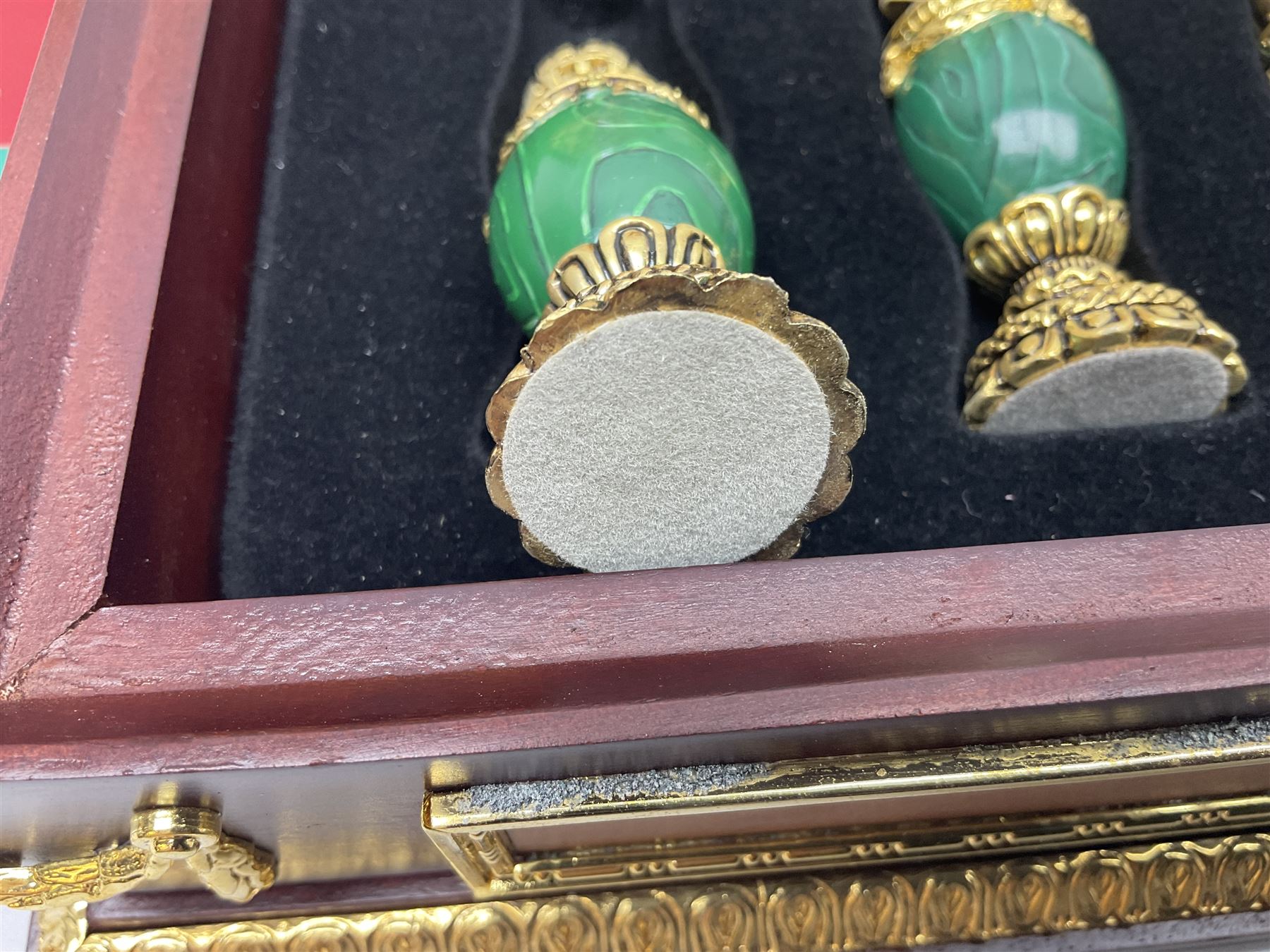 Franklin Mint House of Faberge 'The Imperial Jewelled Chess Set', to include set of chess pieces with malachite finish and a set with carnelian finish and a hardwood chess board