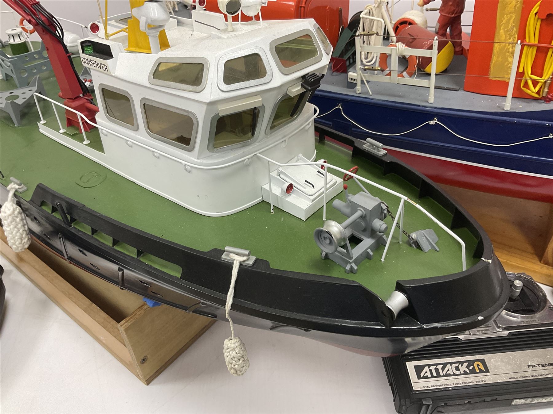 Two remote controlled kit-built plastic model boats - RNLB Sheerness Lifeboat Helen Turnbull L92cm and 'Conserver' Grangemouth L76cm; each on wooden stand; together with three remote control units