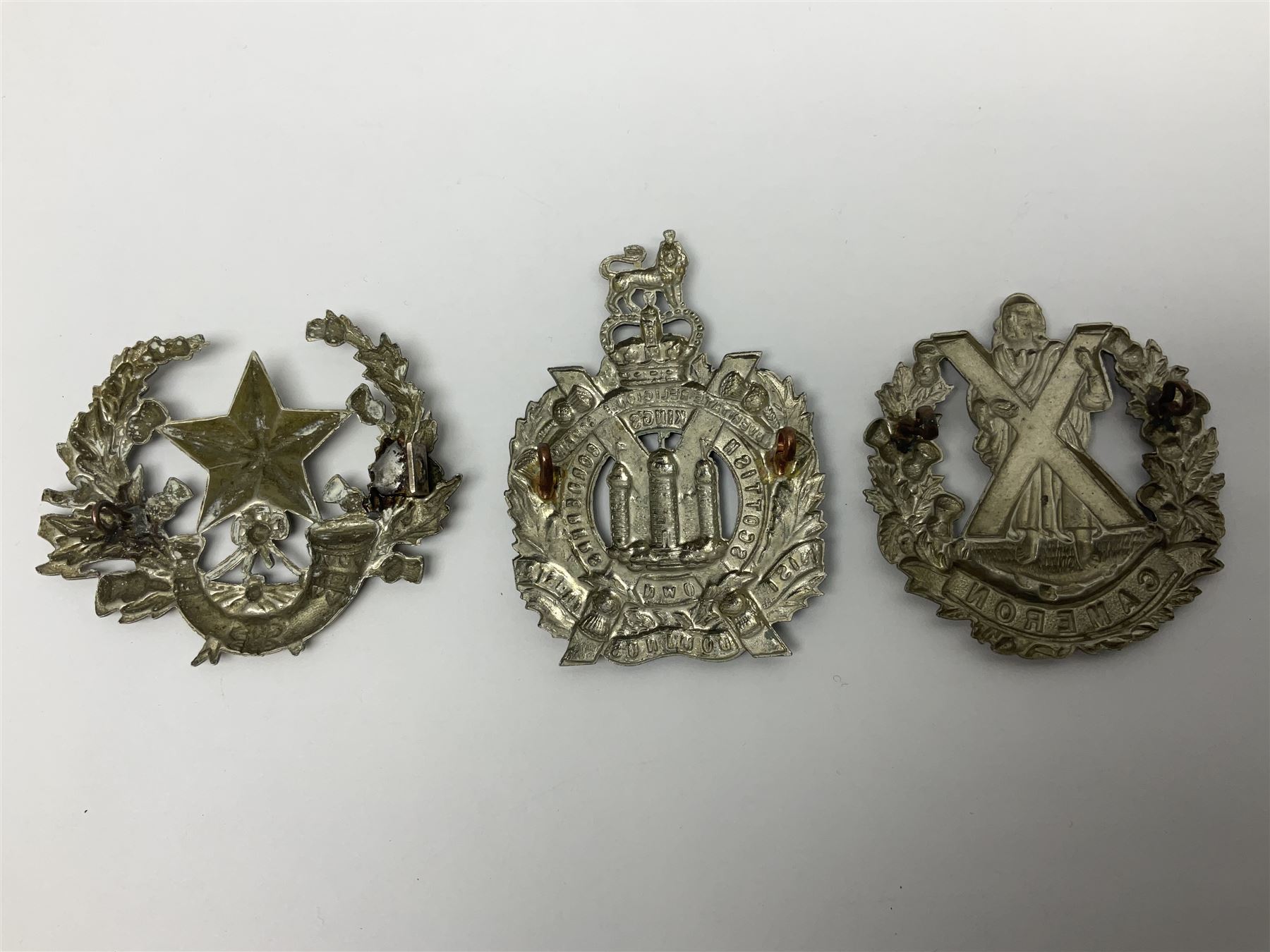 Thirteen Scottish metal Glengarry badges including Black Watch, Highland Regiment, Cameronians, Argyll & Sutherland, Seaforth Highlanders, Kings Scottish Own Borderers etc