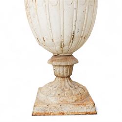 Pair of Victorian white painted cast iron lotus garden urns on stop fluted and lobed plinth bases