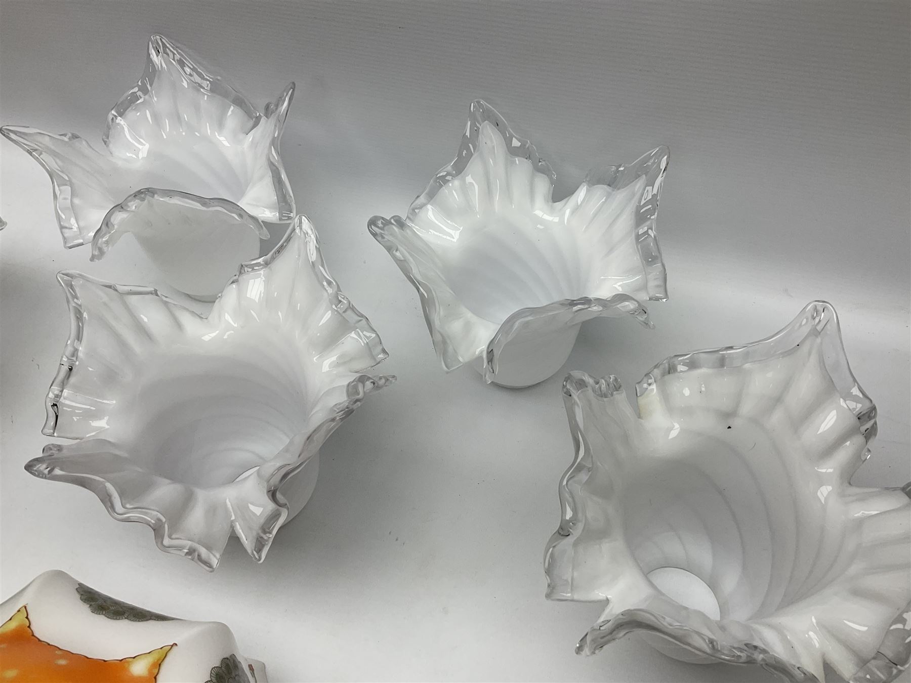 Milk glass lampshade decorated with peacocks, together with a Tiffany style lampshade, a set of five white frilled lamps shades etc 