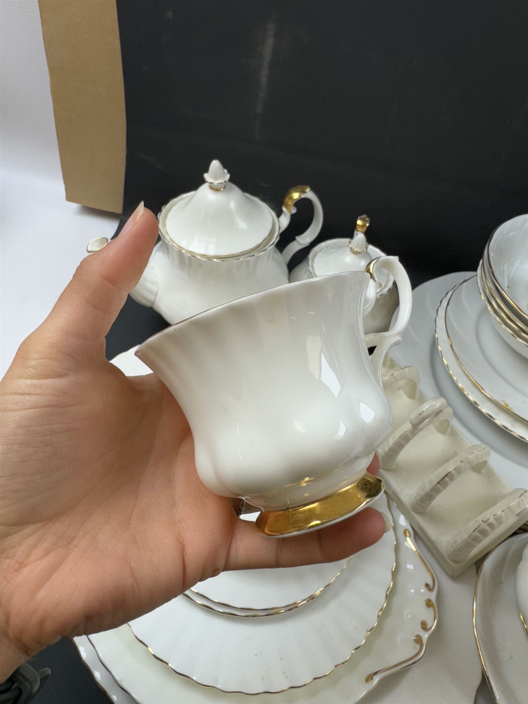 Royal Albert Val D'or part tea and dinner service, including two coffee pots, two teapots, milk jug, covered sucrier etc together with matching items 