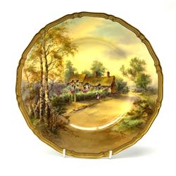 A Royal Worcester cabinet plate, decorated with and titled verso Anne Hathaway's Cottage, signed H Stinton, within a gilt rim, with black printed mark beneath, D27cm