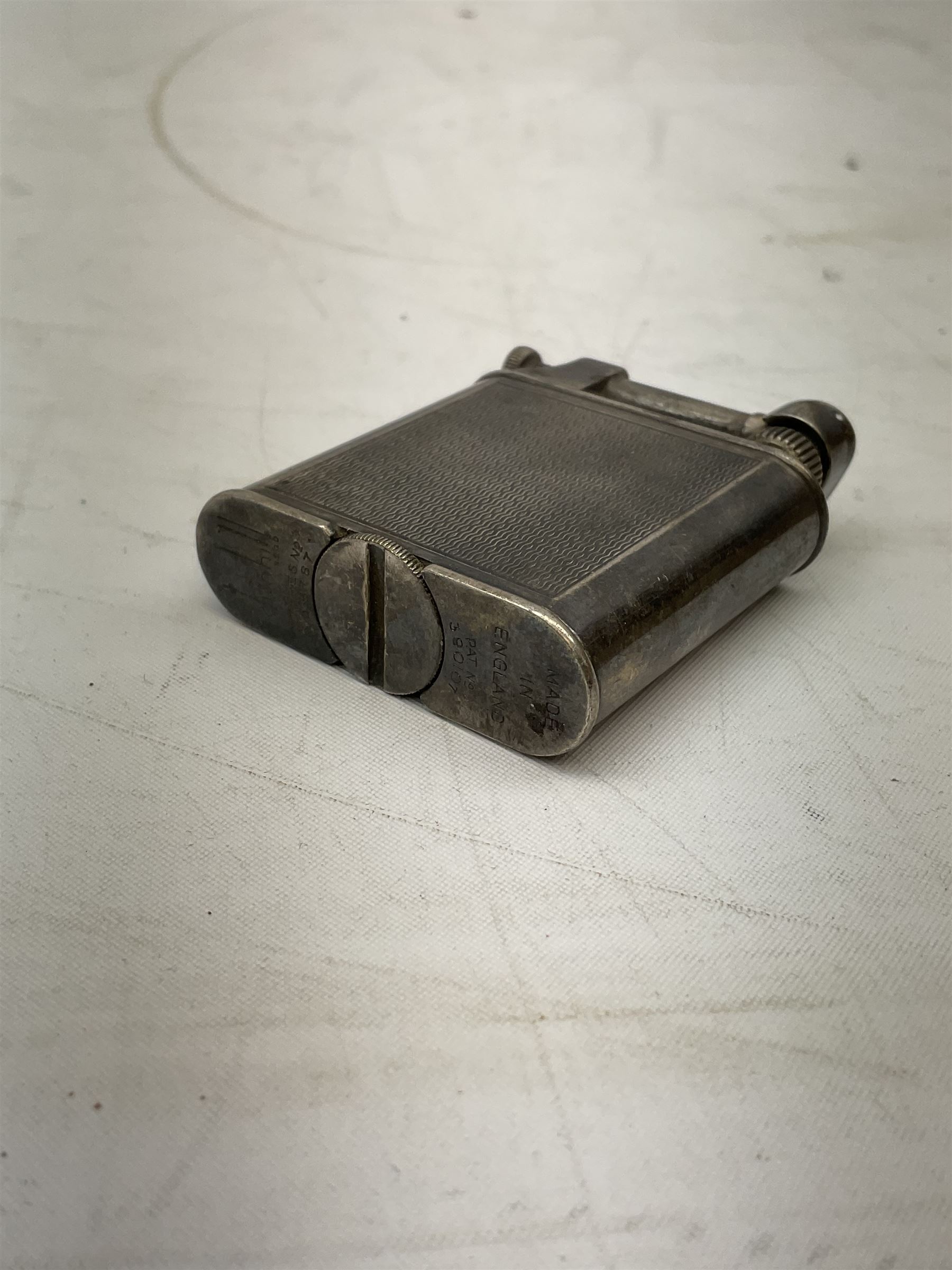 Dunhill silver plated lift-arm lighter, of rectangular form with engine turned decoration, signed Dunhill, base impressed Pat. No. 390107, H5cm
