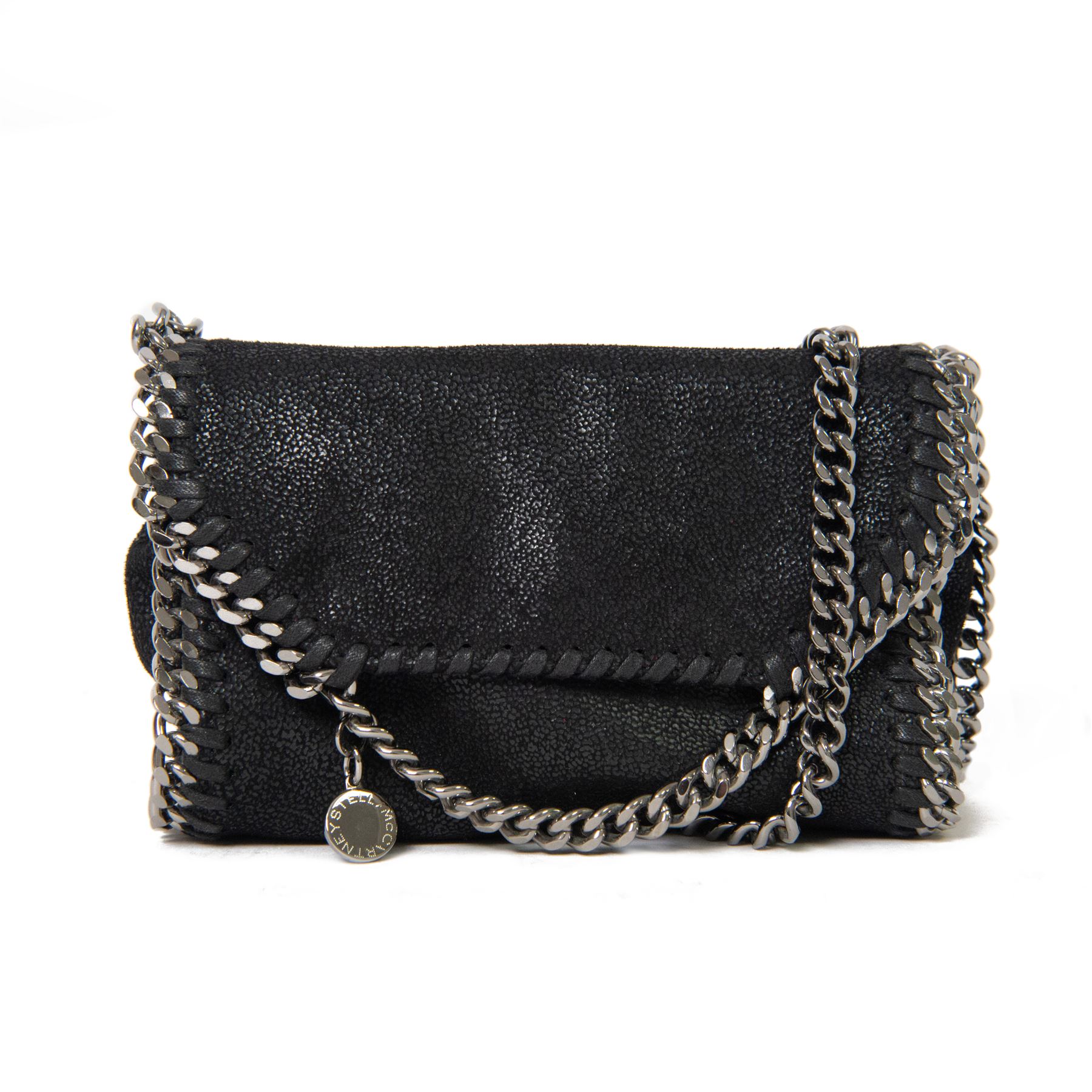 Stella McCartney Falabella black shaggy deer cross-body bag, the compact foldover design with signature silver-tone curb chain trim and chain strap, logo disc charm and pink logo lining, stamped Stella McCartney Made in Italy, with dust bag