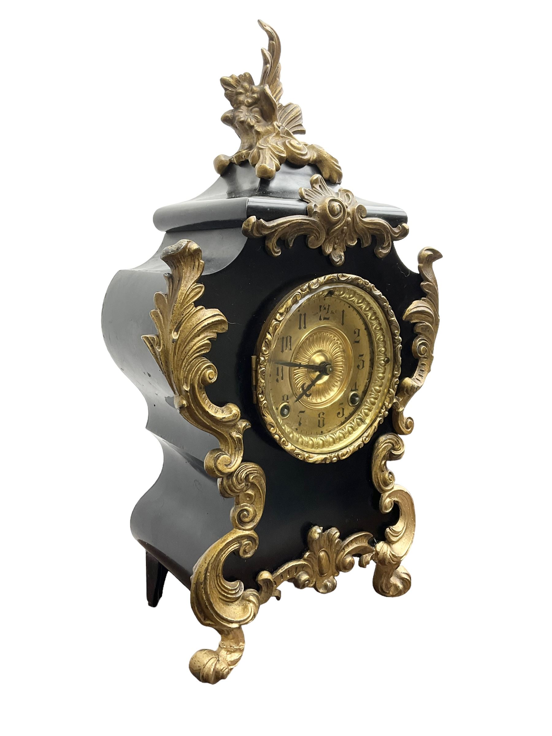 Ansonia - American late 19th century steel cased 8-day mantle clock in a Rococo case with decorative brass mounts, brass dial with Arabic numerals, steel hands and a repousse dial centre, twin train striking movement sounding the hours and half hours on a gong. with pendulum and key.