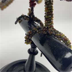 Victorian bead and wire model of a parrot, of polychrome beads, with glass eyes, on ebonised wooden base with turned support, H33cm