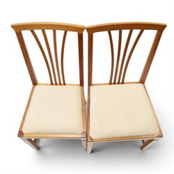 Knightman - set of nine cherrywood dining chairs, with fan splat backs and upholstered seats, raised on square legs joined by stretchers, comprising chairs of slight differing widths and one chair with turned front legs and orange upholstery and no Knight carving, the rest with recessed carved knight trademark, by Horace Knight of Old Mill Furniture, Balk near Thirsk 