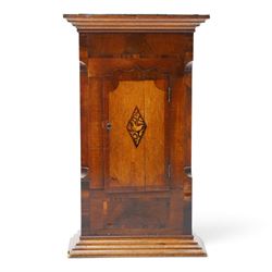 19th century clock trunk cupboard, veneered front with cantered corners, stepped plinth base