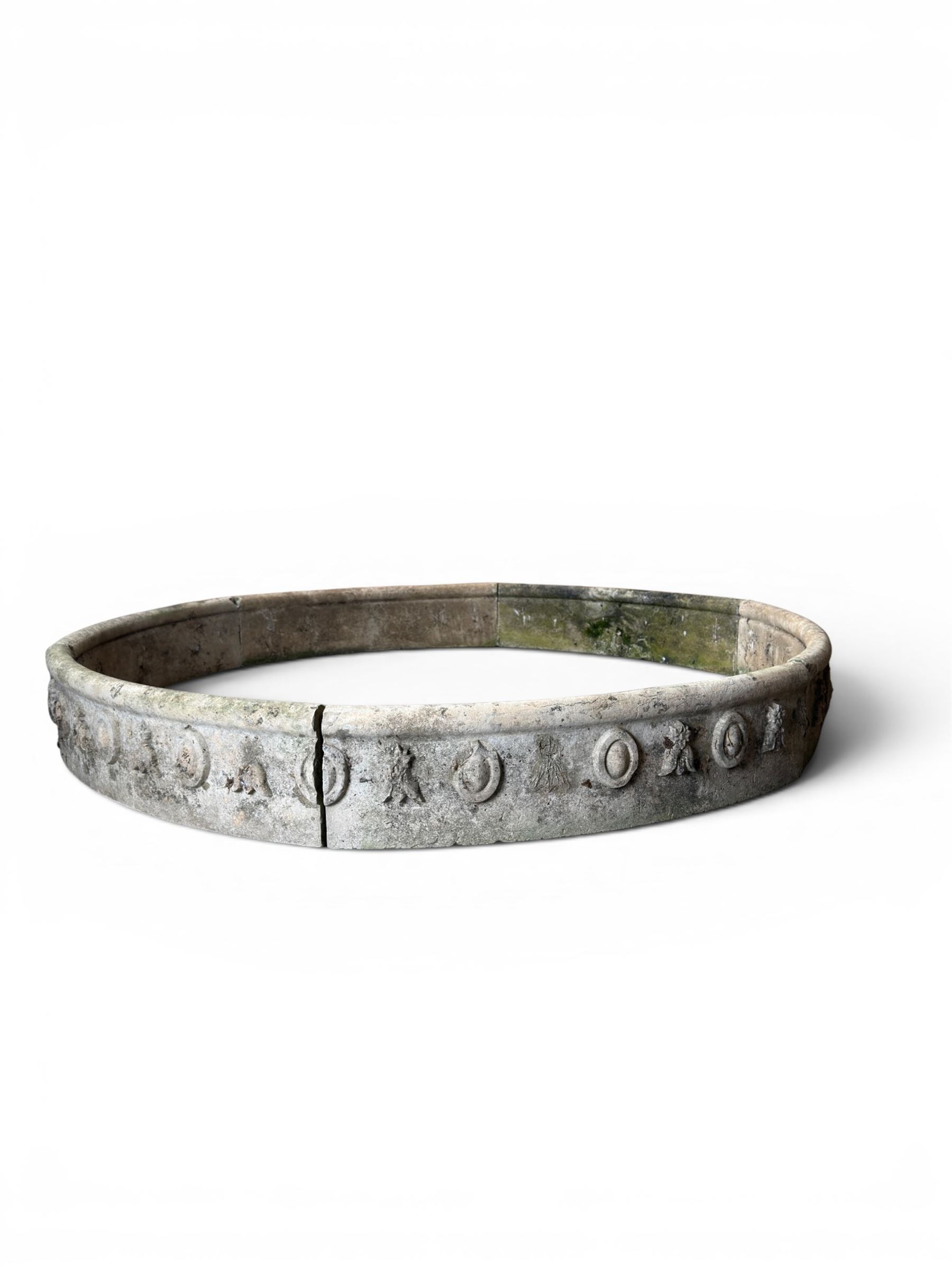 Cast stone planting circle, detailed with flower motifs and roundels
