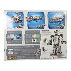 Two Lego Mindstorms sets, comprising 8547 NXT 2.0 and 31313 EV3, both partially built with boxes and instructions