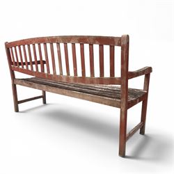 Teak garden bench, with slatted seat and spindle back, shaped armrests, finished in weathered red painted finish.