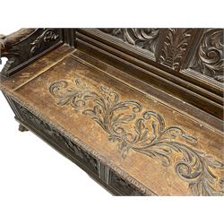 19th century oak hall bench, dentil cresting rail over moulded frame with panelled back carved with fire-breathing mythical beasts and central acanthus leaf motif, scroll carved down-sweeping arms carved with grotesque masks with scrolled foliage and shells, hinged box seat carved with scrolling foliage over panelled front with further carved foliage decoration, on paw carved front feet 