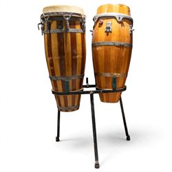 Three conga drums, comprising two Excelsior A. Salvadori Firenze stave-built wooden congas and one similar French example, with skin heads and metal tension mounts, on metal stands with hard carry cases for drums, tallest H79cm, D31cm
