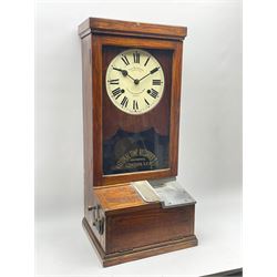 Early 20th century oak cased time recorder, circular Roman dial signed 'Time Recorders Leeds Ltd. Park Lane & Oxford Row Leeds', the glazed door signed 'National Time Recorder Co Ltd. London...'