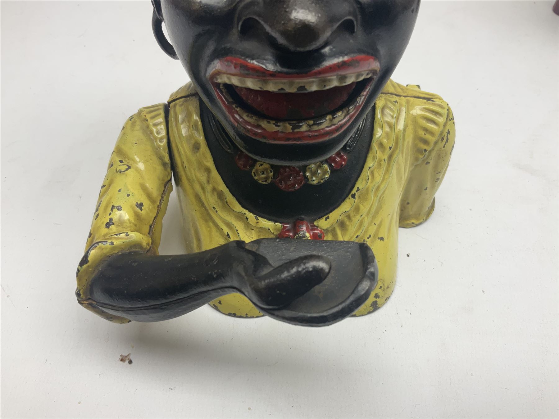 Three early 20th century cast-iron mechanical money banks as a family group comprising mother 'Dinah' patented 1911, father 'Jolly Man' patented 1902 and son 'Little Joe' patented 1910 by John Harper & Co; all with the same hand-to-mouth action; parents H16cm (3)