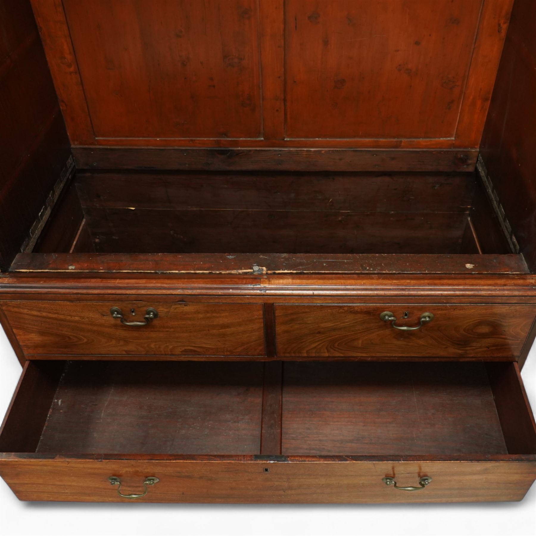 George III mahogany linen press, dentil moulded cornice over a pair of panelled doors enclosing a later fitted interior, lower section with two short over one long cockbeaded drawer, brass swan neck handles, shaped bracket feet