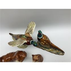 A collection of Beswick figures, comprising ginger cat model no 1898, ginger Persian kitten model no 1886, pheasant in flight model no 849, and pheasant model no 1226b.  