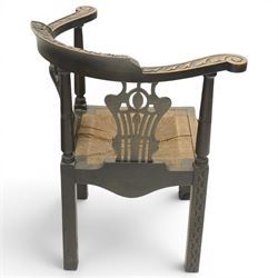 Pair of 19th century carved oak corner chairs, cresting rail carved with central floral bouquet with trailing foliage extending to the scroll arm terminals, pierced back splats with rosette motifs over drop-in rush seats, front cabriole support with acanthus carved knee and ball-and-claw foot