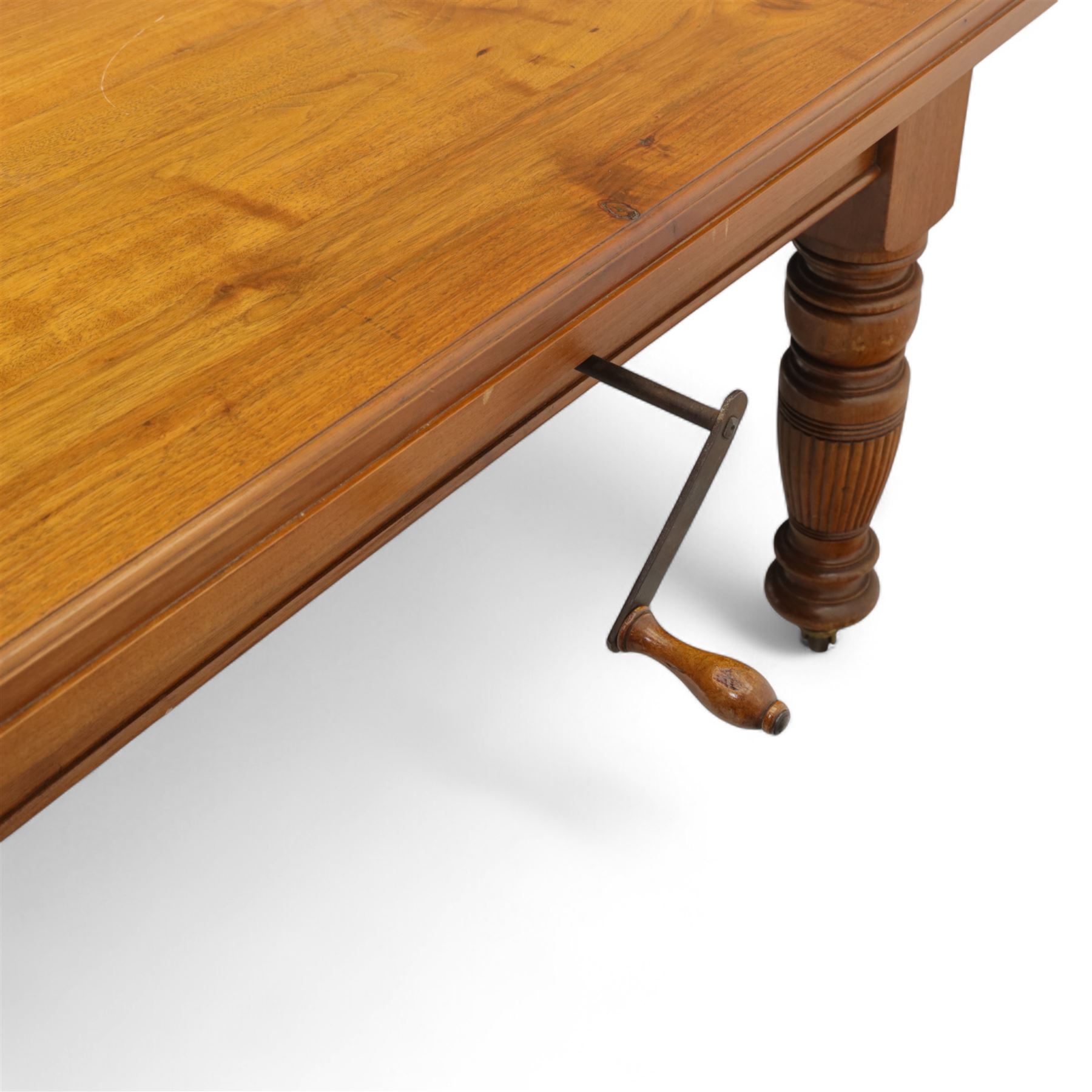 Victorian mahogany extending dining table, rectangular top with chamfered corners above a plain frieze raised on turned reeded legs with castors and two additional leaves, 197cm fully extended, and a set of six early 20th century oak upholstered chairs with drop-in seats, arched panelled back splat and close studded border on turned front legs joined by stretchers, 47x41x109cm 