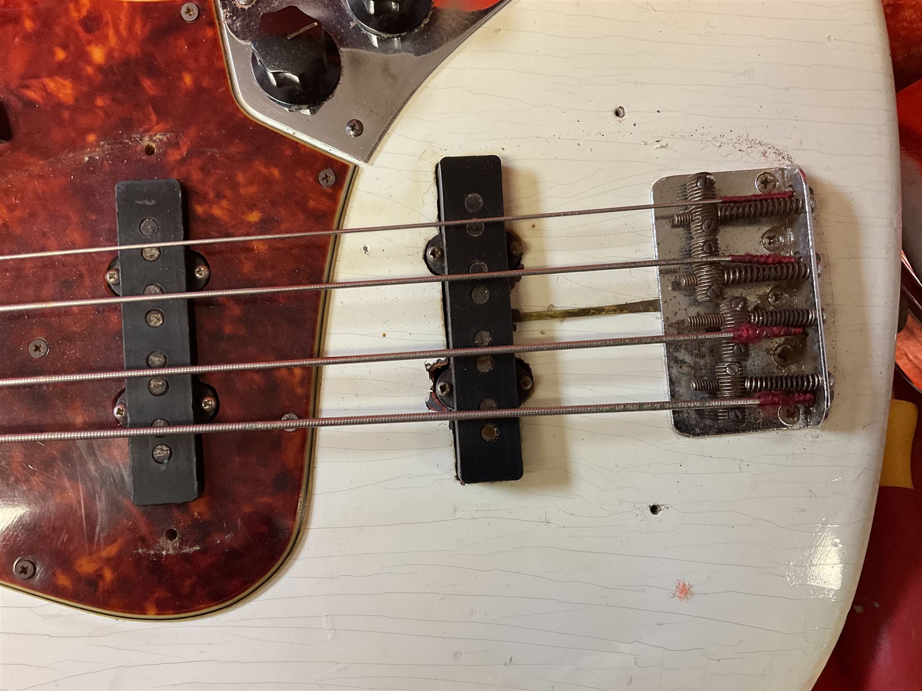 1963 Fender Jazz three-knob bass guitar; impressed with date code 7AUG63A on end of neck and serial no.L08587 on back plate; all original but re-finished in white in the 1970s; sold with photographs of the instrument in the 1960s with original finish and in the 1970s re-finished; L117.5cm; in original hard carrying case; Provenance: the professional guitar of Howard Livett from new to his death in 2005. Howard played in The Humperdincks, the backing group for Englebert Humperdinck, also played in the backing group for Max Bygraves and in the band Hedgehoppers Anonymous. The guitar is also sold with a manuscript letter of provenance from Howard's wife.