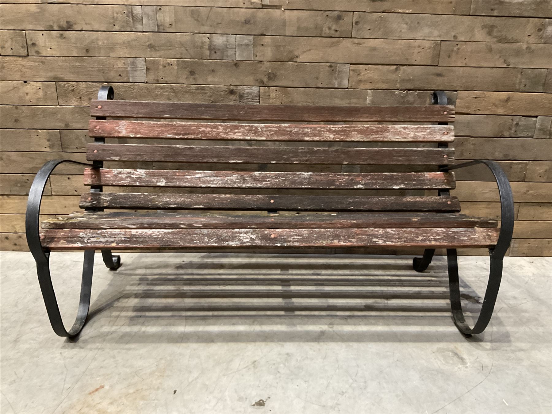 Early 20th century black painted wrought iron and wood slatted garden bench