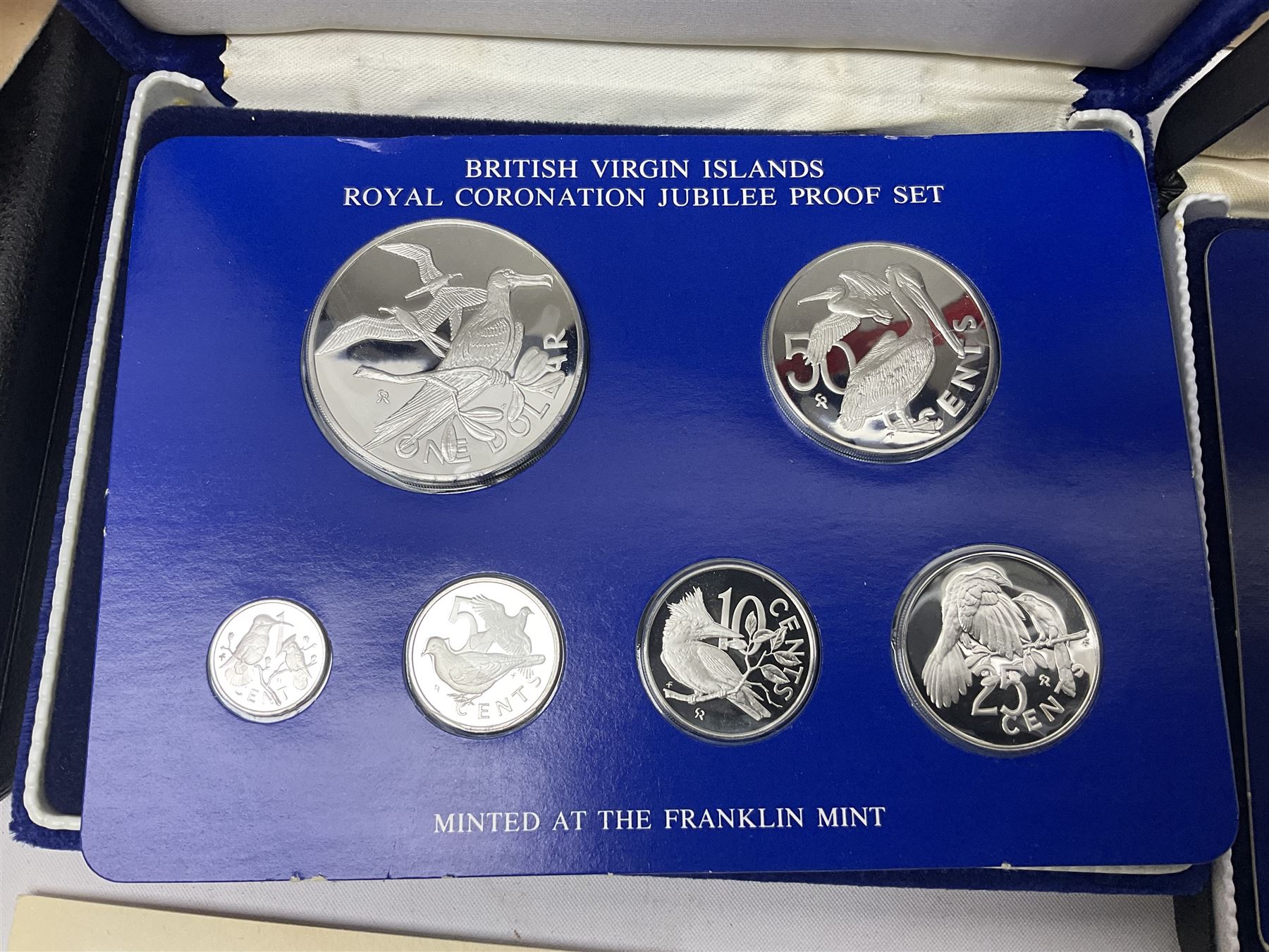Four British Virgin Islands proof coin sets, comprising First Coinage of the British Virgin Islands 1973 proof six coin set, containing silver one dollar coin, 1977 and 1979 proof sets, containing high denomination silver coins, and The Royal Coronation Jubilee 1977 six coin silver proof set, each minted at the Franklin Mint, all cased with certificates, and a Solomon Islands 1978 proof seven coin set, containing silver five dollar coin, minted at the Franklin Mint, cased with certificate (5)