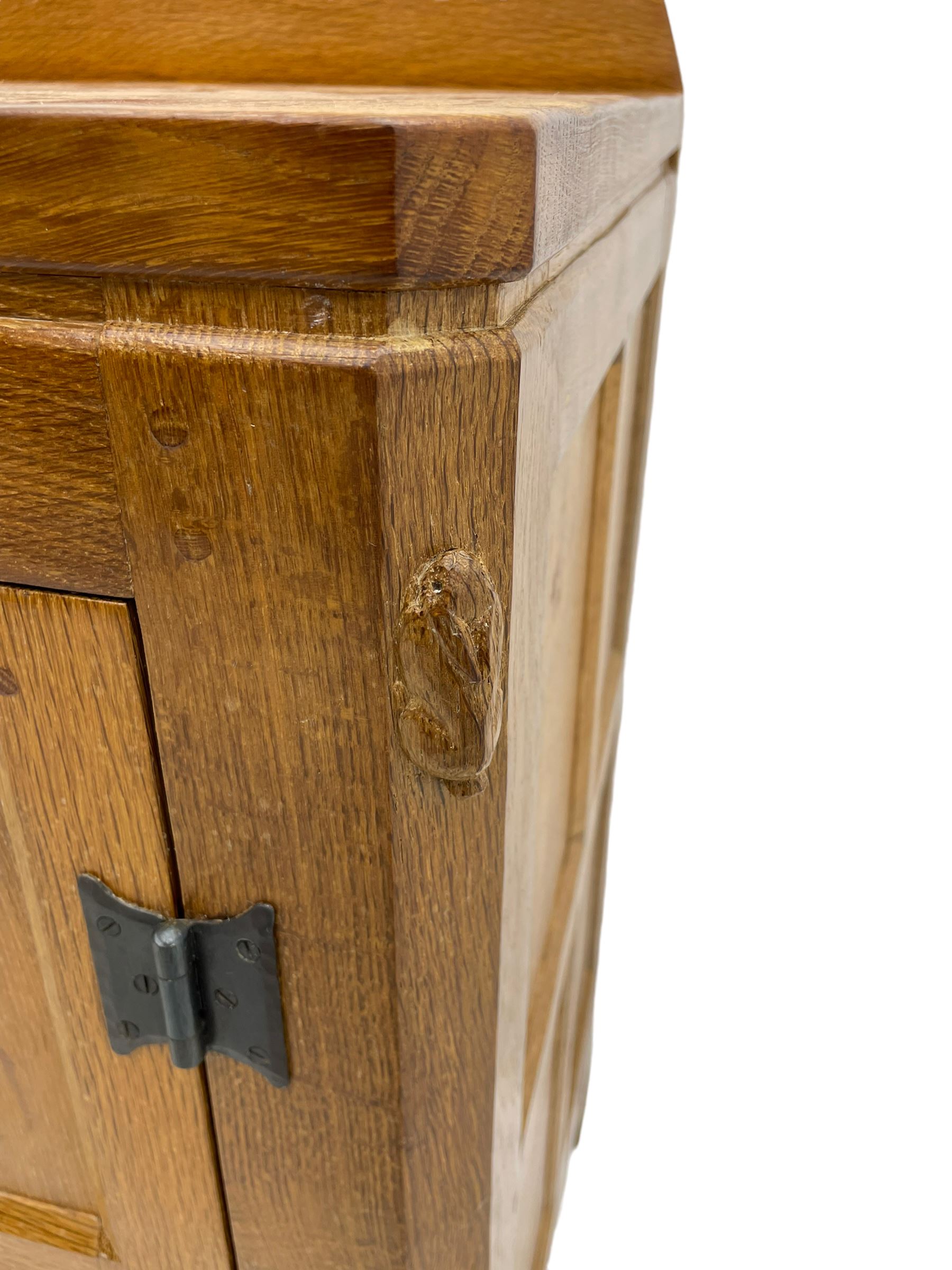 Rabbitman - adzed oak sideboard, fitted with three central drawer and two flanking cupboards, panelled doors with iron latches and hinges, carved with rabbit signature, by Peter Heap, Wetwang