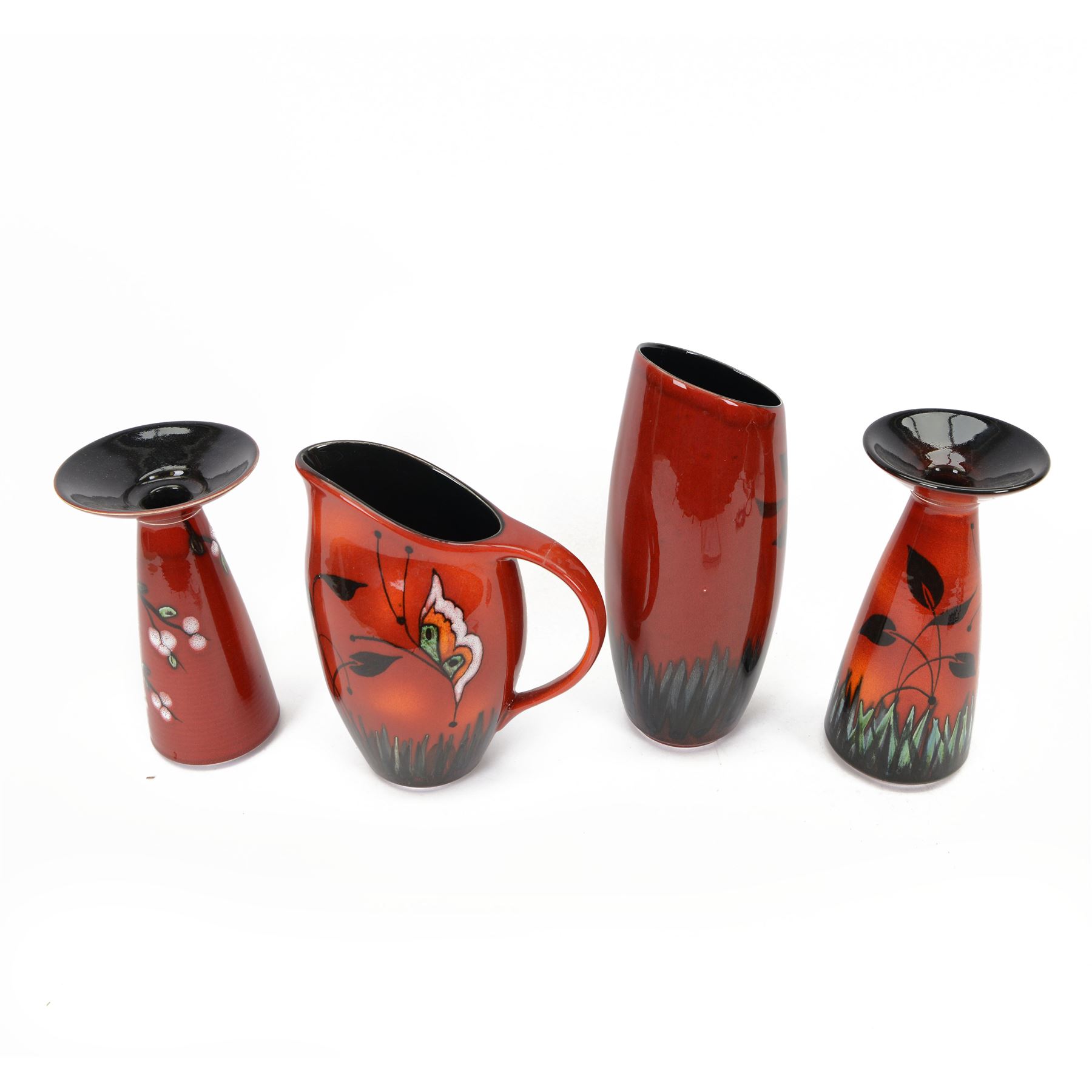 Two Poole Pottery vases decorated in Butterfly pattern, together with matching jug and another Poole Pottery vase decorated in cherry blossom