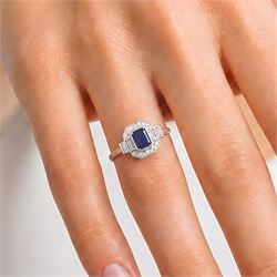 Platinum sapphire and diamond ring, single octagonal cut sapphire of approx 1.15 carat, flanked by two baguette cut diamonds and milgrain set round brilliant cut diamond surround, hallmarked, total diamond weight approx 0.35 carat