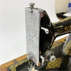 A Singer sewing machine, serial number Y9629162, in oak case with carry handle and key. 