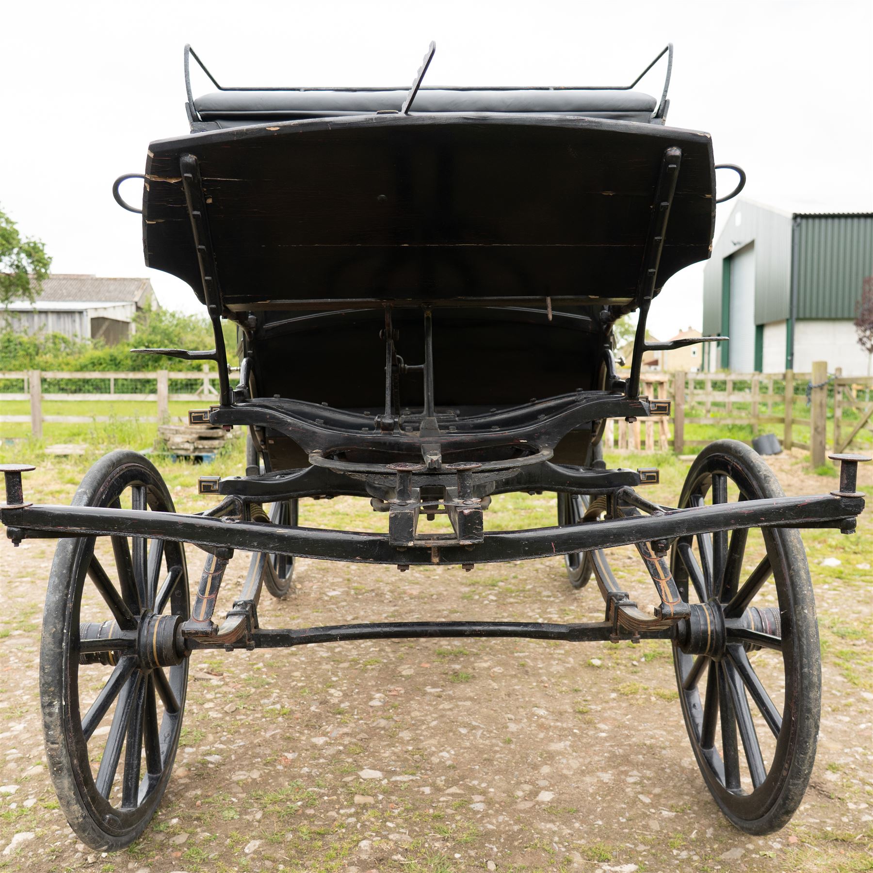 Town Coach by John Marstons Birmingham - Ex Film

A black painted five glass Town Coach by John Marston's Carriage Works Ltd, Birmingham, with enclosed glazed passenger compartment, curved front glass, external coachman's box seat and pole for driving with a pair of horses. The carriage has a timber coach body with buttoned black leather interior, blue upholstered seat cushions, plated exterior door handle, maker plates to the body and step, and John Marston marked hub caps. Mounted on black painted wooden spoked wheels with rubber tyres, leaf spring suspension, underbody turntable steering and iron fittings throughout.
Featured on the film set of 'Victoria' with Jenna Coleman

Features

• Black painted enclosed coach body
• Glazed passenger compartment with five windows
• Curved front glass
• Buttoned black leather interior
• Blue upholstered seat cushions
• External coachman's box seat
• Timber coach body
• Wooden spoked wheels
• Rubber tyres
• Leaf spring suspension
• Underbody turntable steering
• Pole for pair of horses
• Iron foot steps
• Plated exterior door handle
• Maker plates for John Marston's Carriage Works Ltd, Birmingham
• John Marston marked hub caps
• Featured on the film set of Victoria with Jenna Coleman

Dimensions:
Overall length: 390 cm
Width: 190 cm
Height: 214 cm

Wheel Diameters:
Front wheels: 104 cm
Rear wheels: 134 cm

Seating:
Coachman's box: 2
Passenger compartment: 4