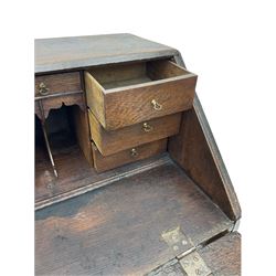 Georgian oak bureau, fall front enclosing fitted interior, four long graduating drawers, on bracket feet