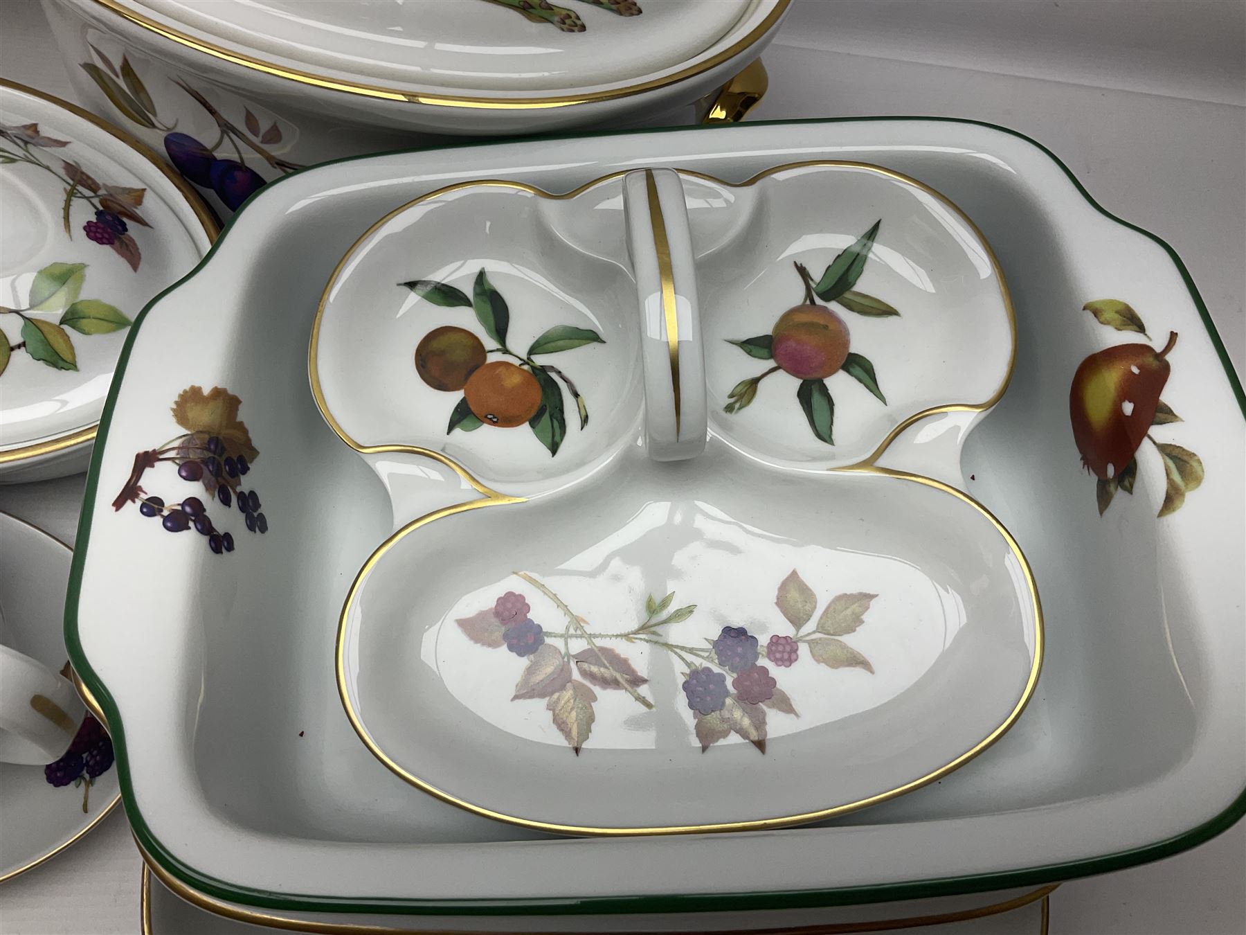 Royal Worcester Evesham pattern, including covered pot de cremes, twin handle tureen, serving dishes, flan dishes, side plates etc  