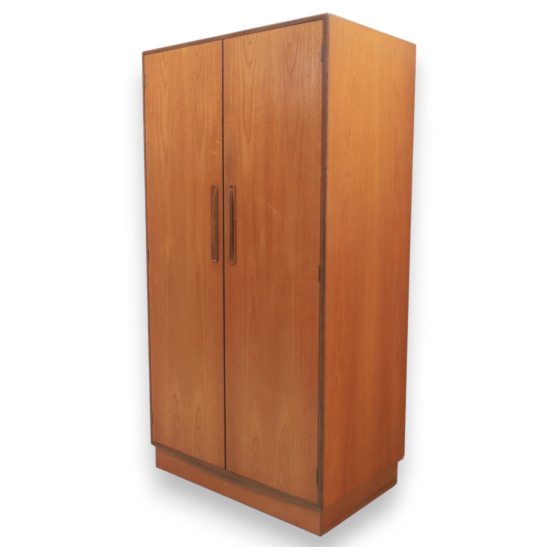 G Plan - 'Fresco' teak double wardrobe, twin doors enclosing a single clothes rail, on a recessed plinth base with castors beneath  