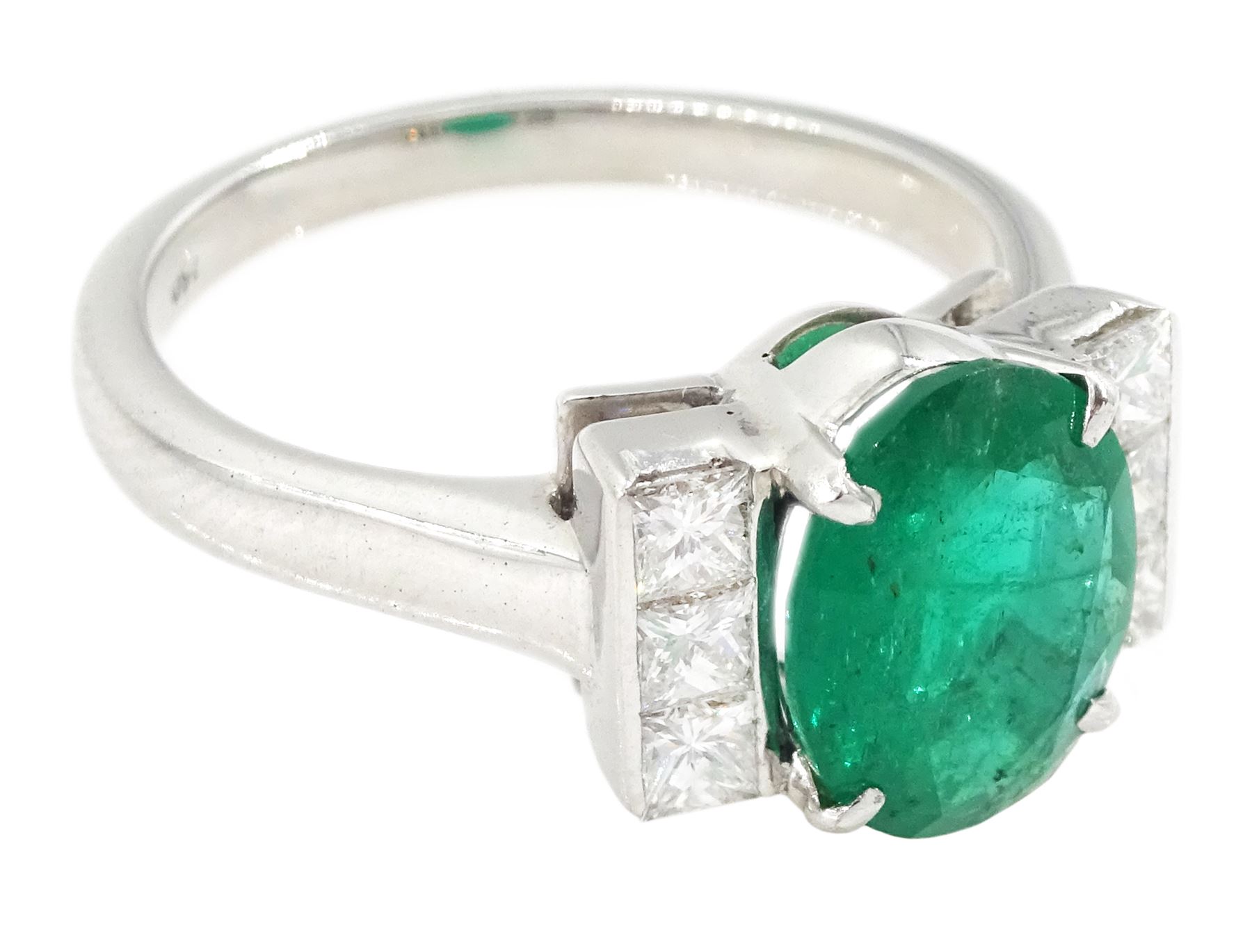 18ct white gold emerald and diamond ring, single oval cut emerald, each side set with three princess cut diamonds, stamped 750, emerald approx 1.90 carat, total diamond weight approx 0.50 carat