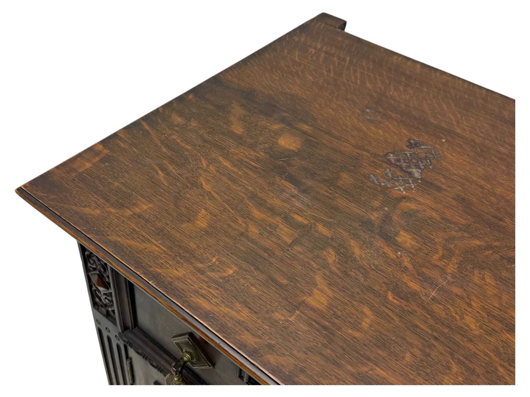 Jacobean-style oak dresser base with two frieze drawers above three cupboards with panelled and moulded decoration, fitted with drop handles, supported on bun feet, circa 1900